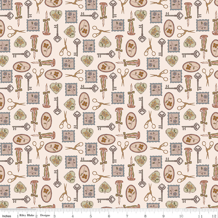 Charmed Latte fabric with decorative keys, scissors, candlesticks, floral frames, and hearts on cream with ruler for scale.