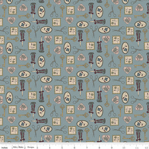 Charmed Storm fabric with golden keys, scissors, candlesticks, floral frames, and blush hearts on blue-gray with ruler for scale.