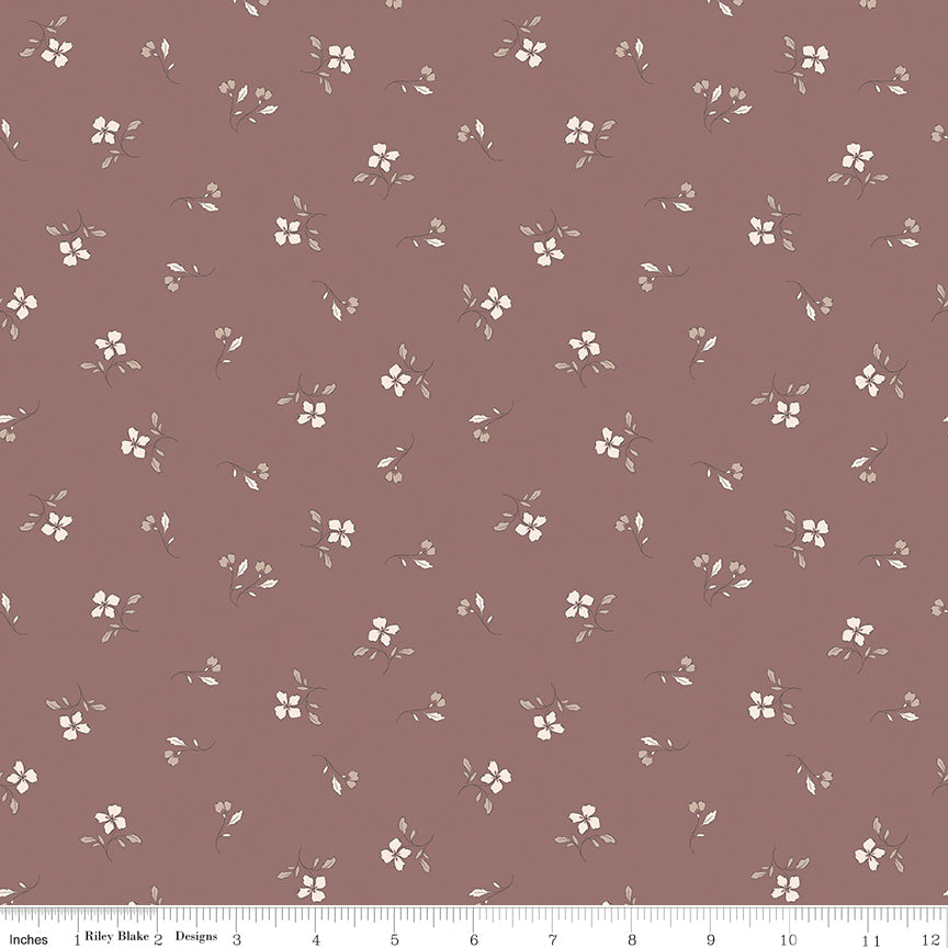 Iris Canyon Rose fabric with ivory flowers, taupe leaves, and delicate buds on a dusty rose background with ruler for scale.