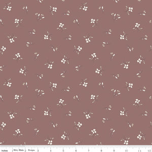 Iris Canyon Rose fabric with ivory flowers, taupe leaves, and delicate buds on a dusty rose background with ruler for scale.