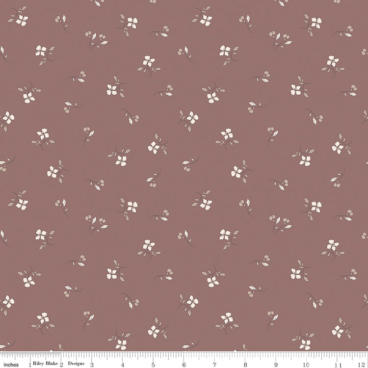 Iris Canyon Rose fabric with ivory flowers, taupe leaves, and delicate buds on a dusty rose background with ruler for scale.