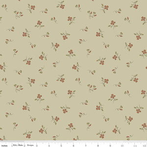 Iris Meadow fabric with rust-colored flowers and olive leaves scattered on pale yellow-green with ruler for scale.