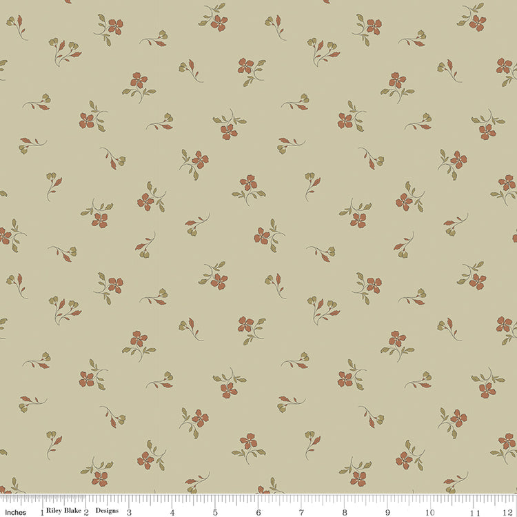 Iris Meadow fabric with rust-colored flowers and olive leaves scattered on pale yellow-green with ruler for scale.