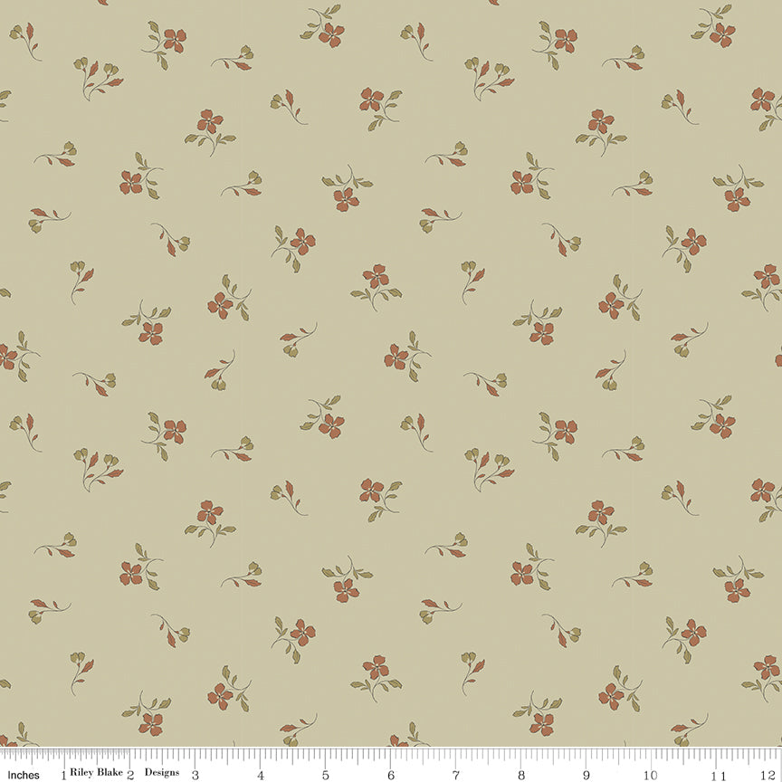 Iris Meadow fabric with rust-colored flowers and olive leaves scattered on pale yellow-green with ruler for scale.