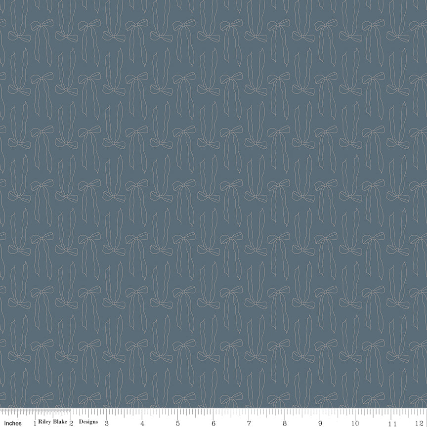 Bows Thunder fabric with slender taupe ribbon bow outlines and flowing tails on smoky blue-gray with ruler for scale.