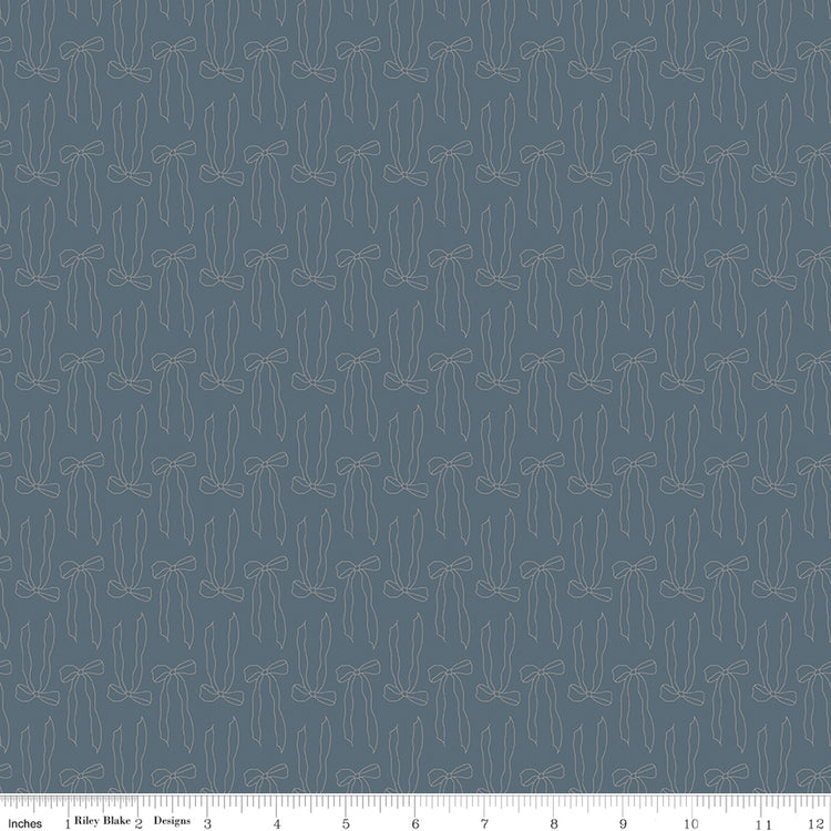 Bows Thunder fabric with slender taupe ribbon bow outlines and flowing tails on smoky blue-gray with ruler for scale.