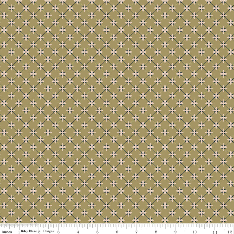 Stella Lemongrass fabric with blush flowers and a dark blue-gray diamond lattice on golden olive with ruler for scale.