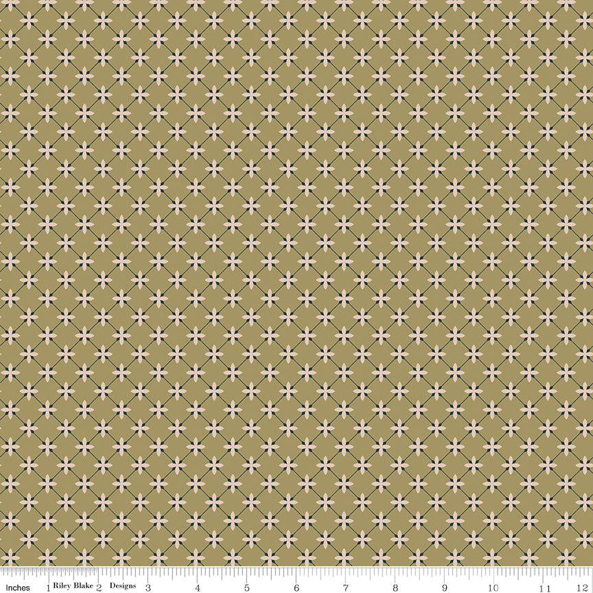 Stella Lemongrass fabric with blush flowers and a dark blue-gray diamond lattice on golden olive with ruler for scale.