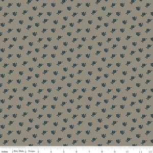 Magnolia Light Gray fabric with small charcoal-blue floral sprigs scattered across a warm gray background with ruler for scale.