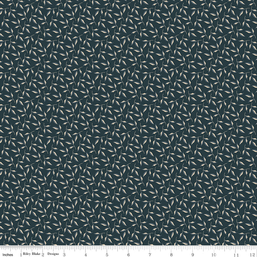 Evergreen Carbon fabric with curling stems and cream and slate-blue leaves on dark charcoal with ruler for scale.
