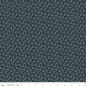 Evergreen Carbon fabric with curling stems and cream and slate-blue leaves on dark charcoal with ruler for scale.