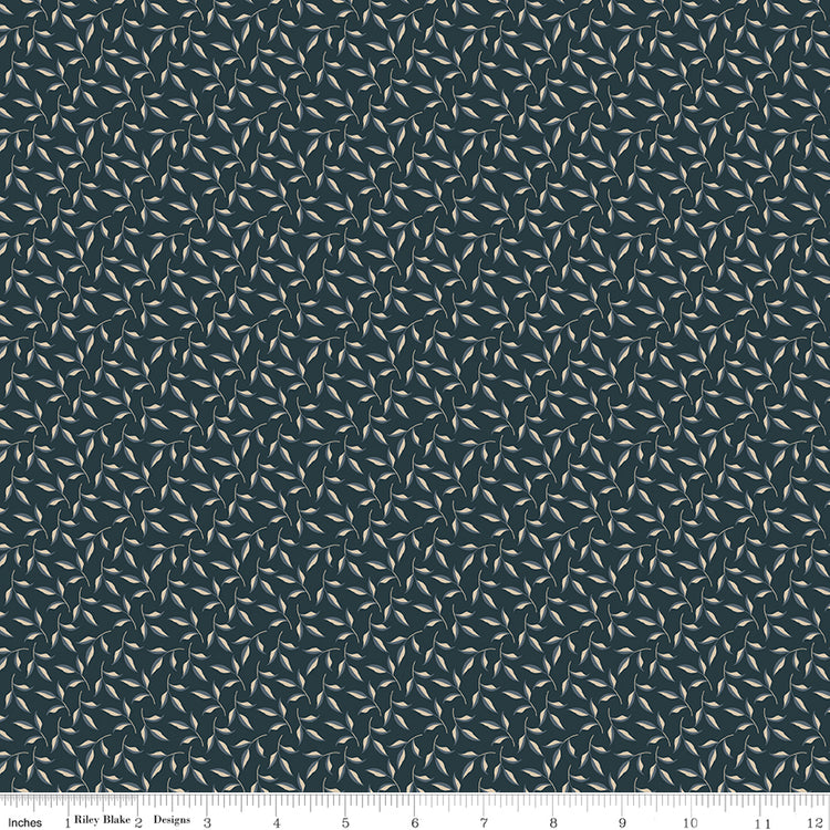 Evergreen Carbon fabric with curling stems and cream and slate-blue leaves on dark charcoal with ruler for scale.