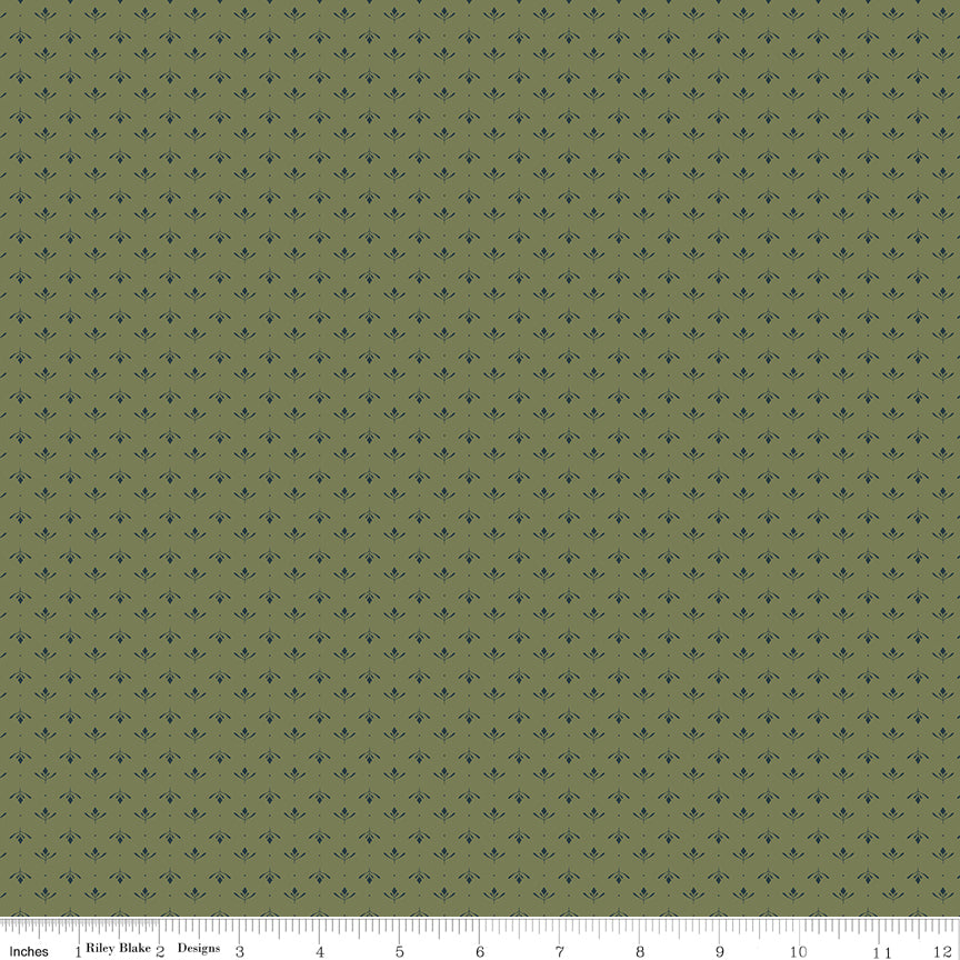 Lottie Green fabric with tiny slate-blue leaf sprigs and dots arranged in rows on muted olive green with ruler for scale.