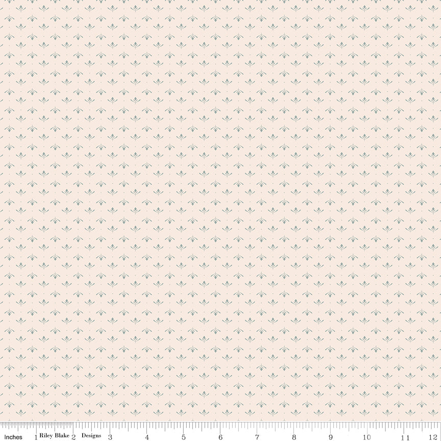 Lottie Latte fabric with tiny blue-gray leaf sprigs and dots in alternating rows on creamy ivory with ruler for scale.