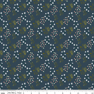 Meadow Blue fabric with white and blush flowers, green leaves, and golden grasses on dark slate blue with ruler for scale.