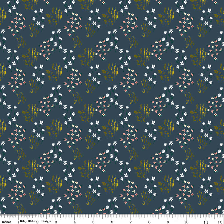Meadow Blue fabric with white and blush flowers, green leaves, and golden grasses on dark slate blue with ruler for scale.