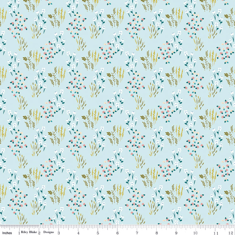 Meadow Powder fabric with white, pink, and cream flowers, teal leaves, and golden grasses on light blue with ruler for scale.