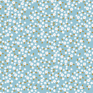 Blossoms Dream fabric with white flowers, pale pink centers, and golden leaves on a light blue background.