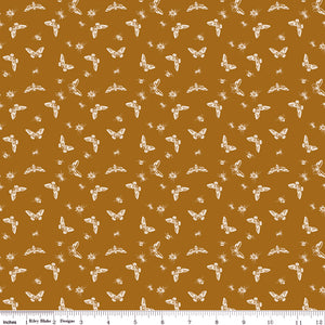 Flutter Butterscotch fabric with cream butterflies, moths, and small insects on a golden ochre background with ruler for scale.