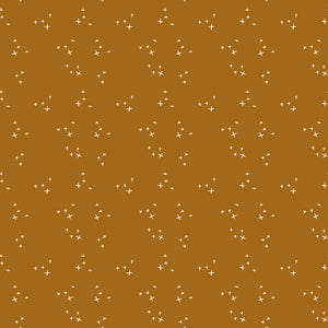 Scatter Butterscotch fabric with scattered cream crosses on a warm golden ochre background.