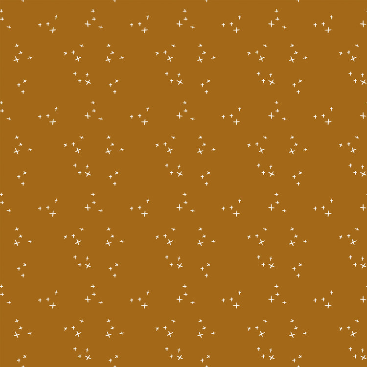 Scatter Butterscotch fabric with scattered cream crosses on a warm golden ochre background.