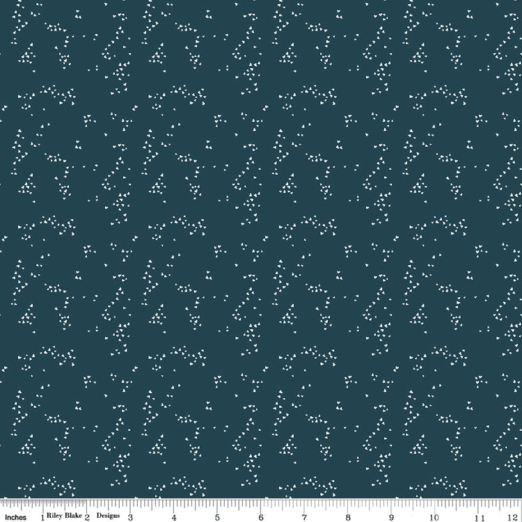 Hearts Blue fabric with tiny ivory hearts scattered in loose clusters on a dark teal-blue background with ruler for scale.