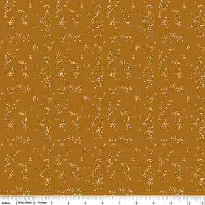Hearts Butterscotch fabric with small cream hearts in scattered clusters on a warm golden ochre background with ruler for scale.