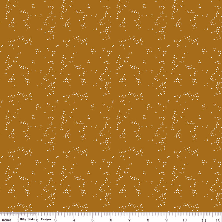 Hearts Butterscotch fabric with small cream hearts in scattered clusters on a warm golden ochre background with ruler for scale.