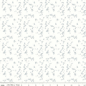 Hearts Off White fabric with tiny slate-blue hearts scattered in irregular clusters on an off-white background with ruler for scale.
