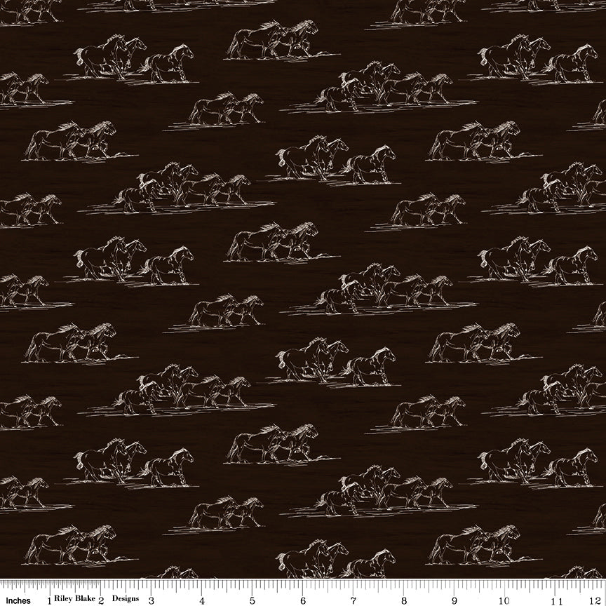 Horse Toile Brown fabric with cream line drawings of running horses on a dark brown background with ruler for scale.