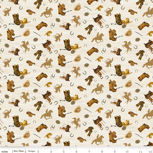 Icon Toss Cream fabric with boots, hats, saddles, horseshoes, and golden horseback riders on cream with ruler for scale.