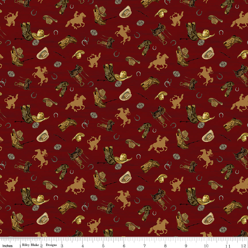 Icon Toss Red fabric with cowboy hats, boots, saddles, horseshoes, and golden horseback riders on deep red with ruler for scale.
