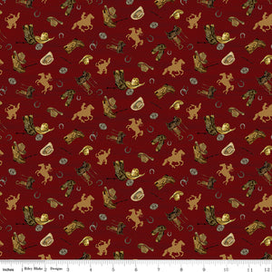 Icon Toss Red fabric with cowboy hats, boots, saddles, horseshoes, and golden horseback riders on deep red with ruler for scale.