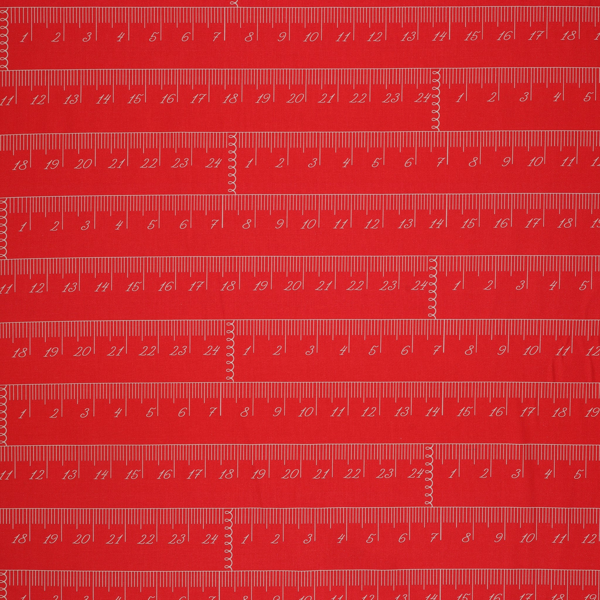 En Vogue Fabric Collection - Chic Rulers Coral: red coral fabric with a repeating pattern of white printed rulers showing inch and centimeter measurements CL64250107-01