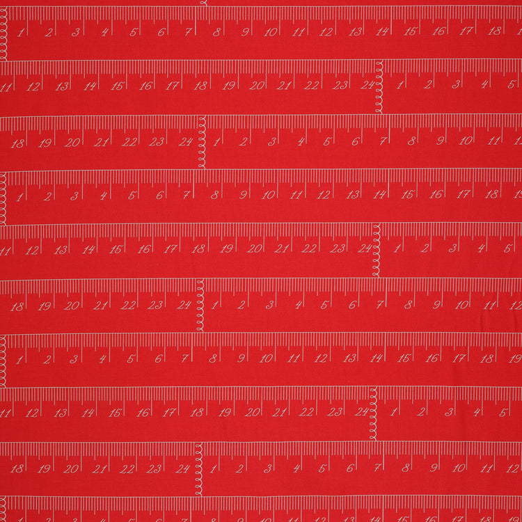 En Vogue Fabric Collection - Chic Rulers Coral: red coral fabric with a repeating pattern of white printed rulers showing inch and centimeter measurements CL64250107-01