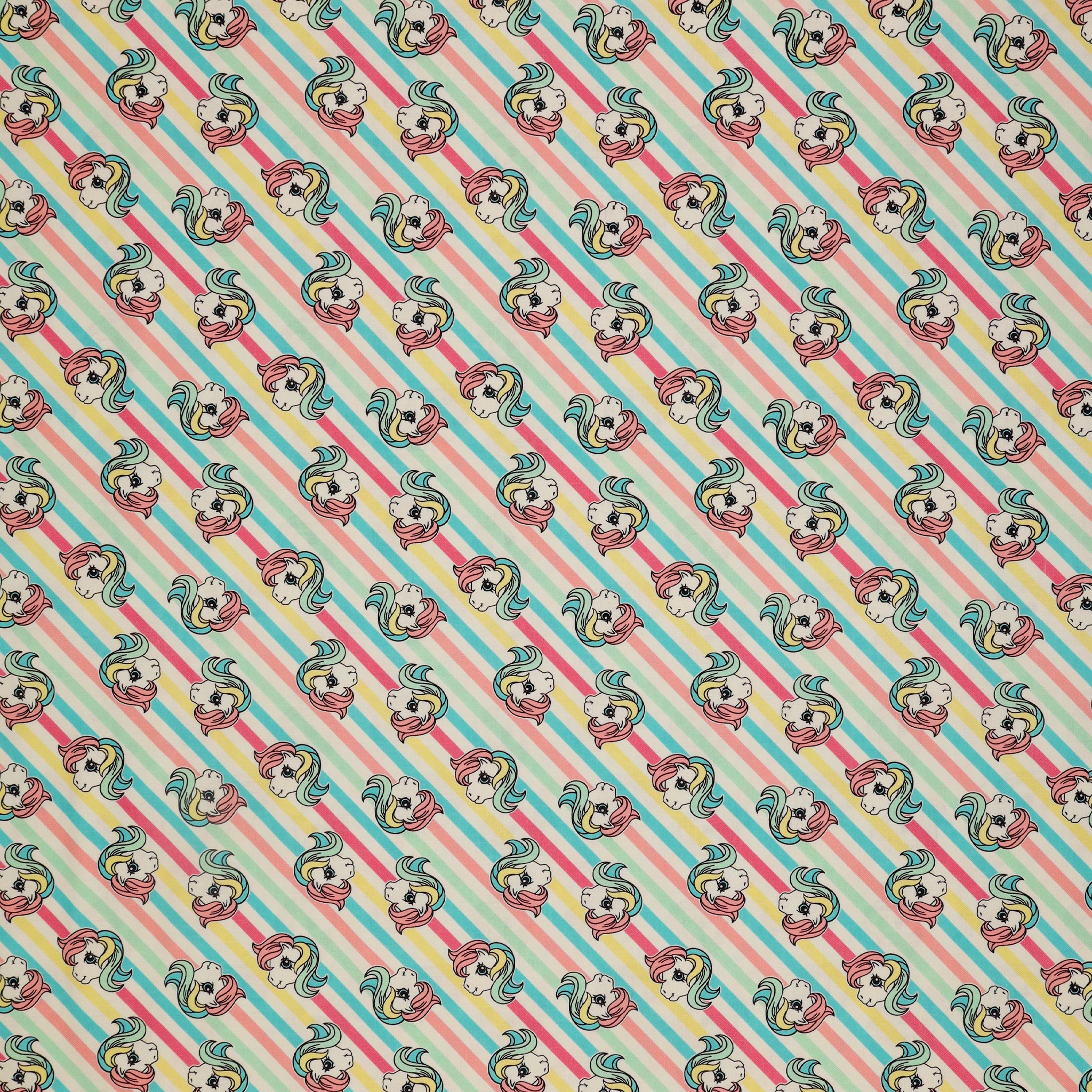 My Little Pony Retro Fabric Collection - Pony Stripe: cartoon pony faces, set against a background of diagonal pastel stripes in blue, pink, and white CL95010204-01