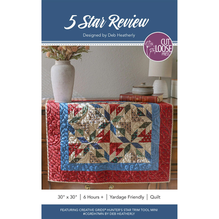 5 Star Review quilt pattern cover showing finished star-block wall hanging on a dresser