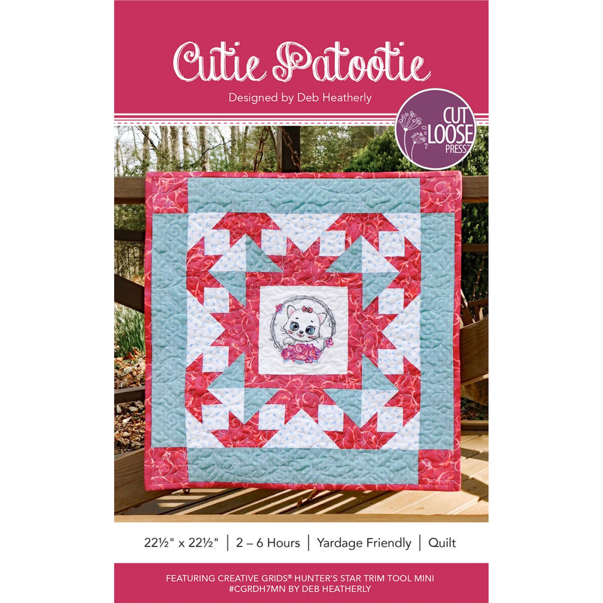 Cutie Patootie quilt pattern cover showing finished wall hanging with kitten center and Hunter's Star border