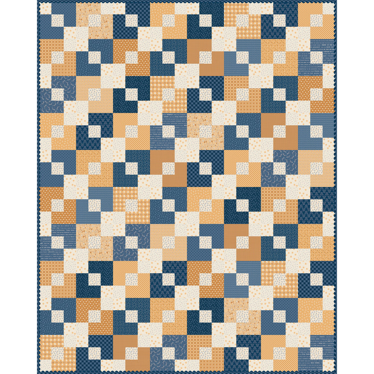 A patchwork quilt featuring a geometric block pattern in navy blue, slate blue, tan, cream, and small orange accents.