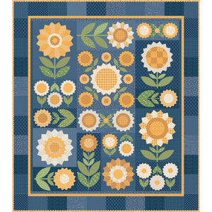 A quilt design featuring stylized sunflowers and floral motifs in yellow, orange, white, and green on a blue patchwork background with a decorative border.