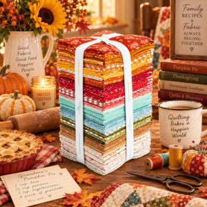 Baked With Love fat quarter bundle displayed in a cozy fall baking and quilting setting.