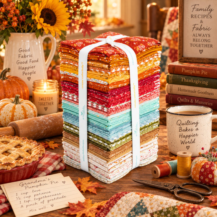 Baked With Love fat quarter bundle displayed in a cozy fall baking and quilting setting.