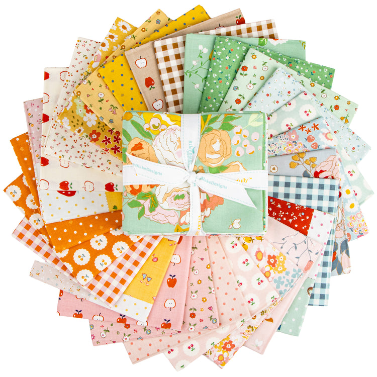 Cotton Nook Fat Quarter Bundle tied with white ribbon, topped with mint floral fabric.