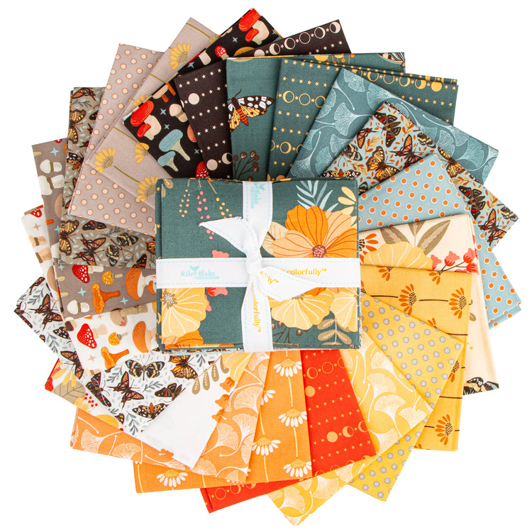 A bundle of folded fabric pieces arranged in a circular fan, with a central folded piece tied by a white ribbon. The fabrics feature autumn-themed patterns including orange pumpkins, yellow flowers, mushrooms, butterflies, and polka dots in teal, orange, yellow, brown, and cream.