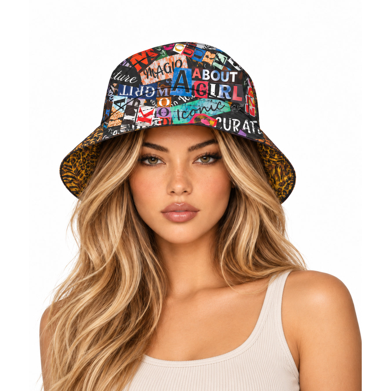 A woman with long blonde hair wearing a bucket hat with a colorful collage print and leopard-print brim, paired with a white ribbed tank top, against a solid white background.