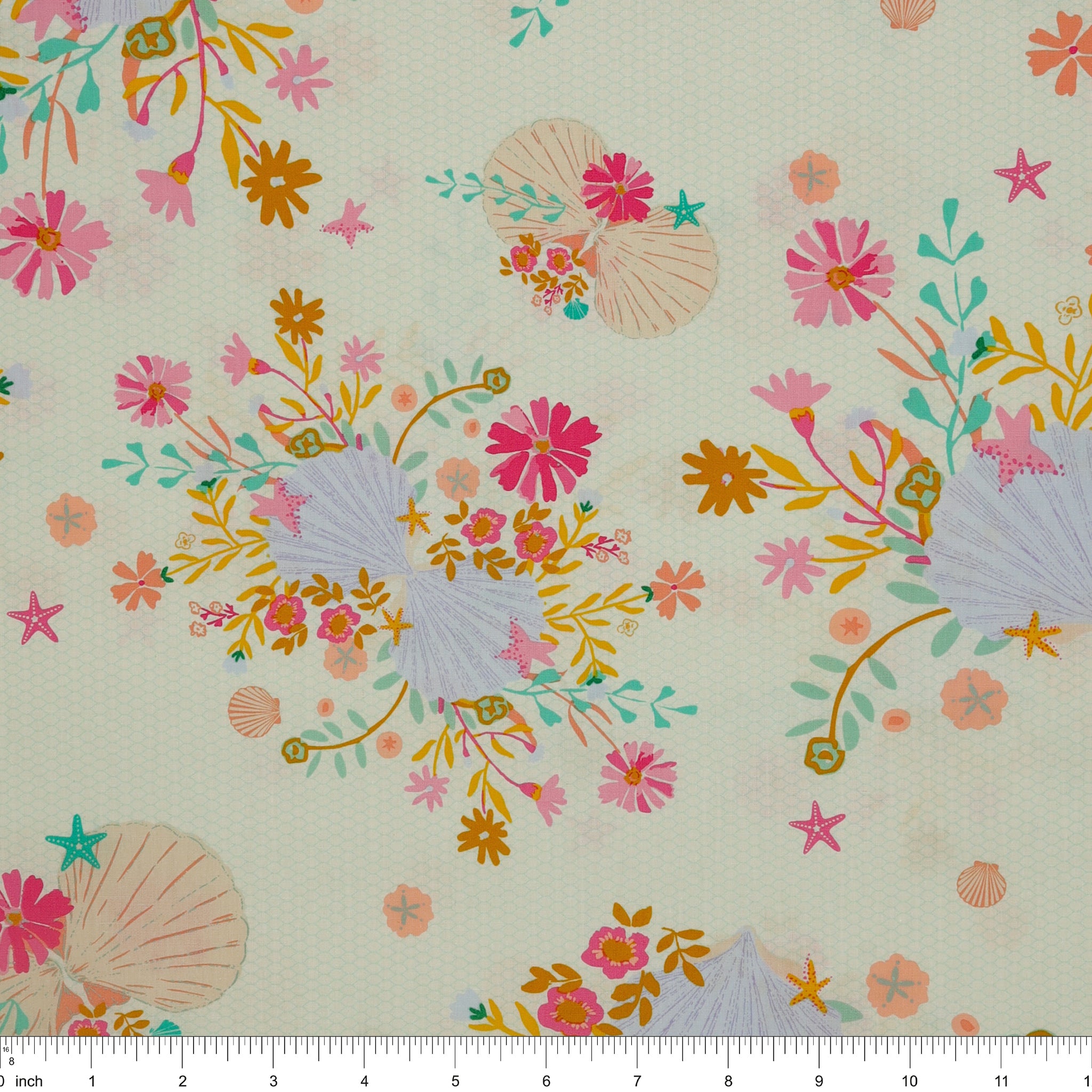 Island Life Seaflower Blossom fabric with seashells, starfish, and colorful flowers on cream with ruler for scale.