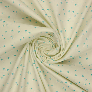 Island Life Tropic Breeze fabric with tiny turquoise palm trees scattered on a soft cream background swirled showing texture.