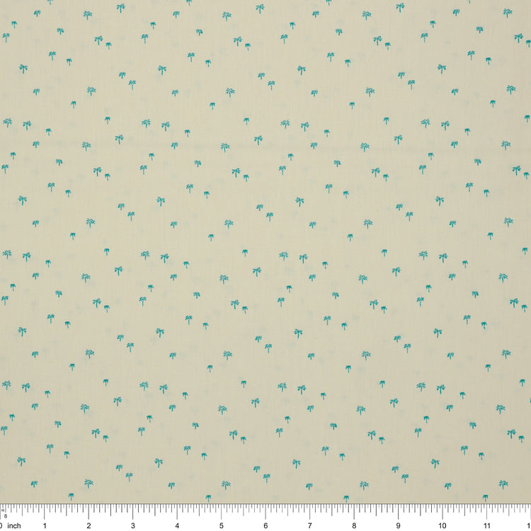 Island Life Tropic Breeze fabric with tiny turquoise palm trees scattered on a soft cream background with ruler for scale.