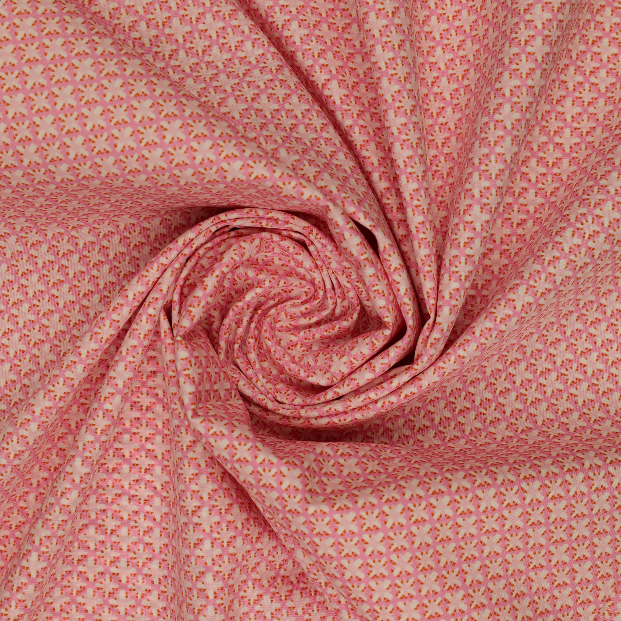 Island Life Summer Rattan fabric with a small woven-inspired geometric pattern in pink and coral swirled showing texture.