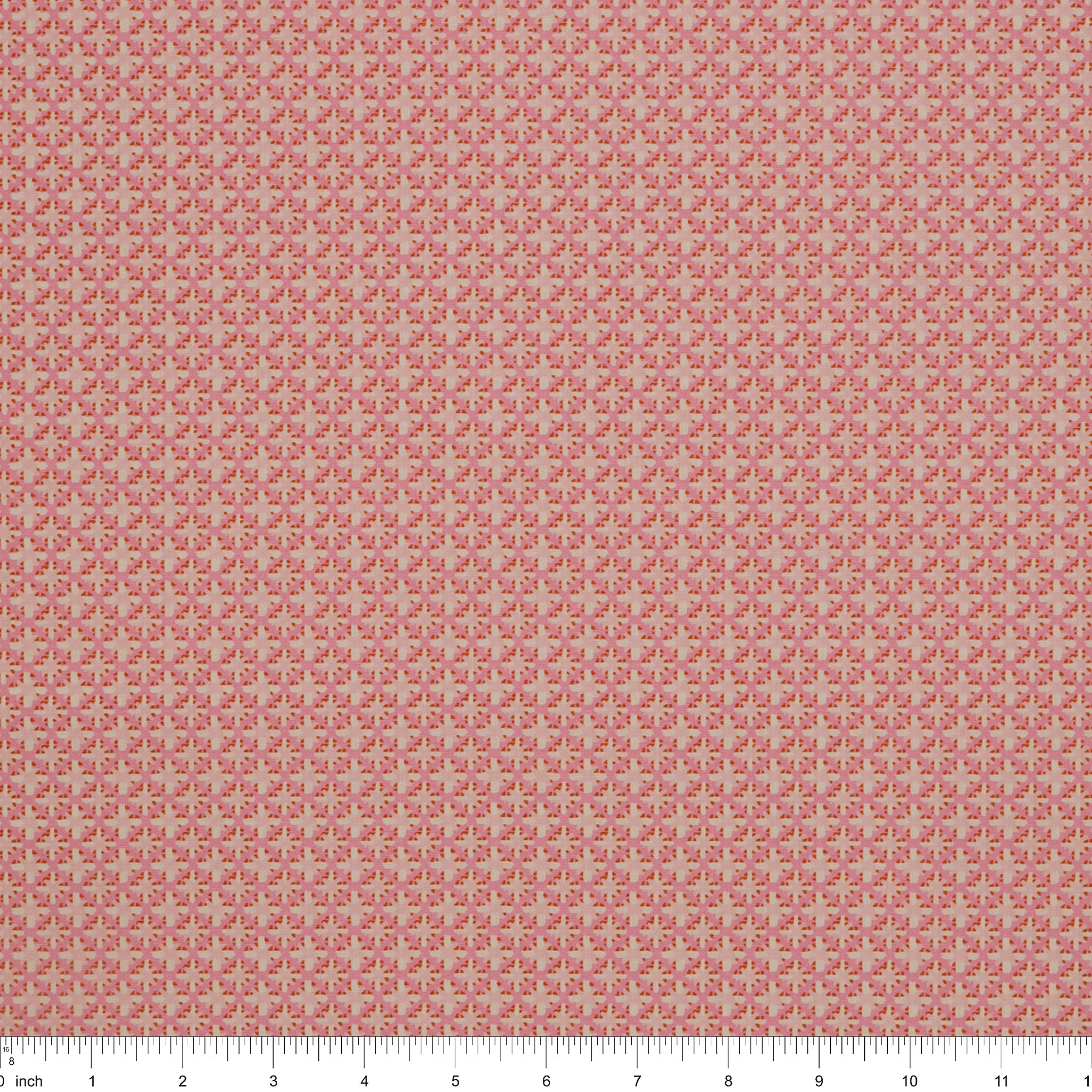 Island Life Summer Rattan fabric with a small woven-inspired geometric pattern in pink and coral with ruler for scale.